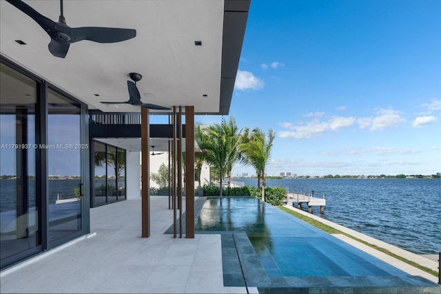 11404 N Bayshore Dr, North Miami, FL 33181 - view of swimming pool featuring a ceiling fan, a water view, a patio, and a dock
