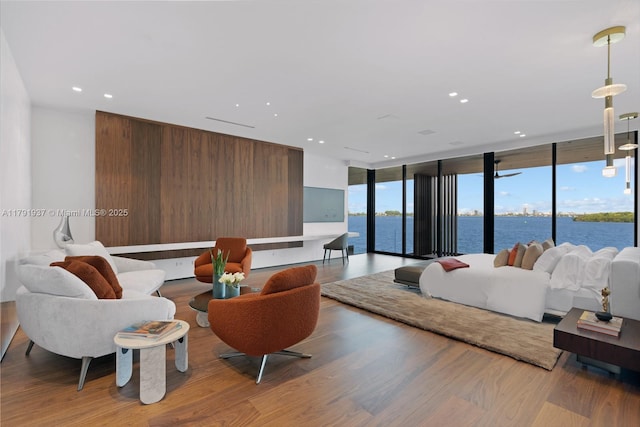 11404 N Bayshore Dr, North Miami, FL 33181 - bedroom featuring light wood-style floors, recessed lighting, a wall of windows, and a water view