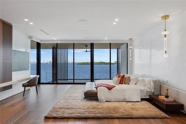 11404 N Bayshore Dr, North Miami, FL 33181 - bedroom with access to exterior, wood finished floors, a wall of windows, recessed lighting, and a water view