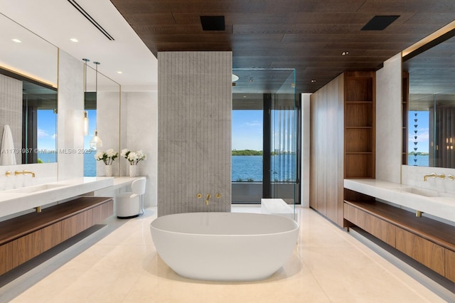 11404 N Bayshore Dr, North Miami, FL 33181 - bathroom featuring a freestanding tub, two vanities, wooden ceiling, tile patterned floors, and a water view