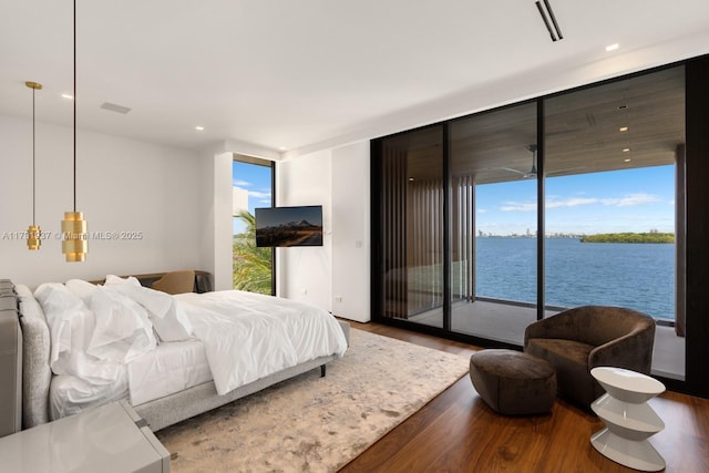 11404 N Bayshore Dr, North Miami, FL 33181 - bedroom featuring access to outside, wood finished floors, expansive windows, and recessed lighting