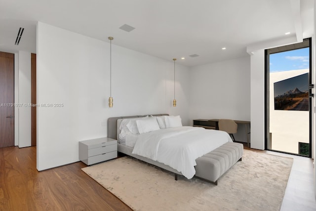 11404 N Bayshore Dr, North Miami, FL 33181 - bedroom featuring wood finished floors, access to outside, and recessed lighting