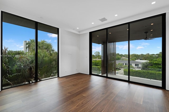 11404 N Bayshore Dr, North Miami, FL 33181 - spare room with floor to ceiling windows, wood finished floors, and recessed lighting