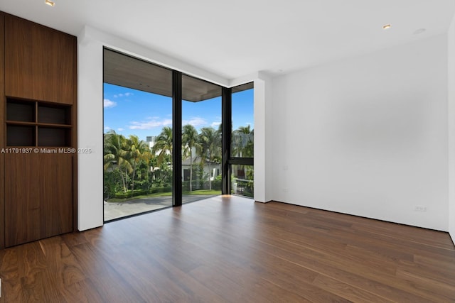 11404 N Bayshore Dr, North Miami, FL 33181 - spare room featuring expansive windows and dark wood-style floors