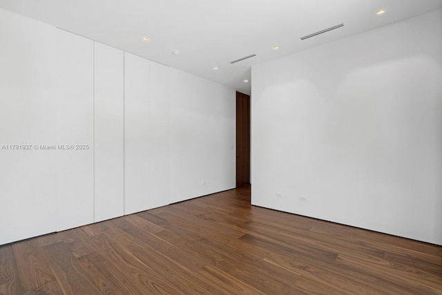 11404 N Bayshore Dr, North Miami, FL 33181 - spare room with wood finished floors and recessed lighting