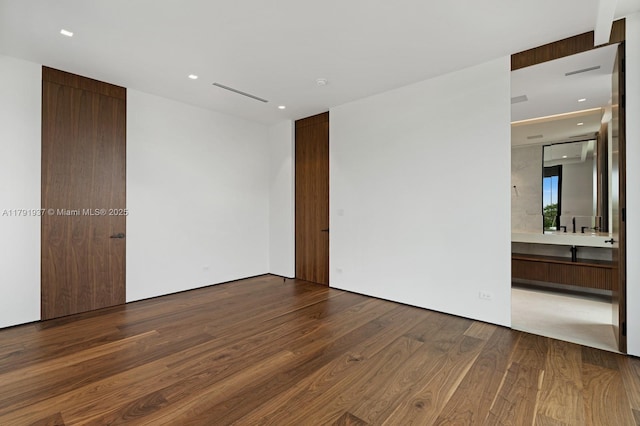 11404 N Bayshore Dr, North Miami, FL 33181 - unfurnished bedroom featuring wood finished floors, recessed lighting, and ensuite bath