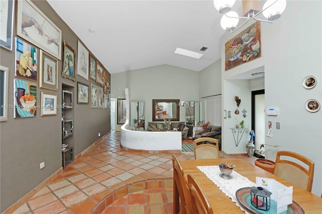 dining space featuring lofted ceiling and a notable chandelier