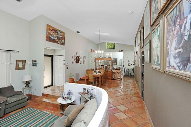 living area featuring visible vents, lofted ceiling, light tile patterned flooring, and a chandelier
