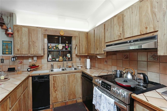 kitchen featuring under cabinet range hood, electric range, tile counters, and a sink