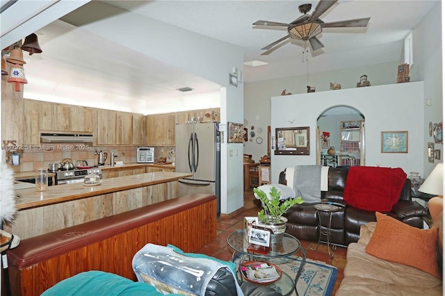 living room with arched walkways, ceiling fan, tile patterned flooring, and visible vents