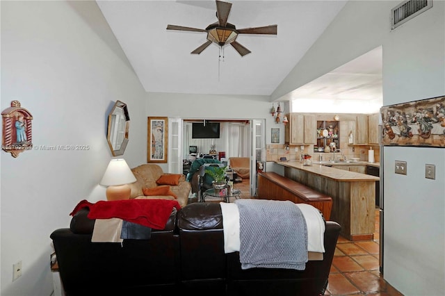 living room featuring visible vents, a ceiling fan, and high vaulted ceiling