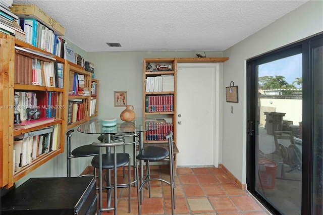 dining area with visible vents and a textured ceiling