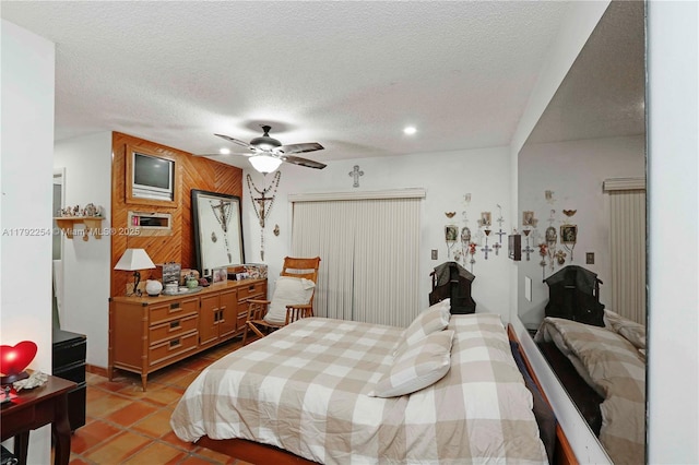 bedroom featuring light tile patterned floors, a ceiling fan, recessed lighting, and a textured ceiling