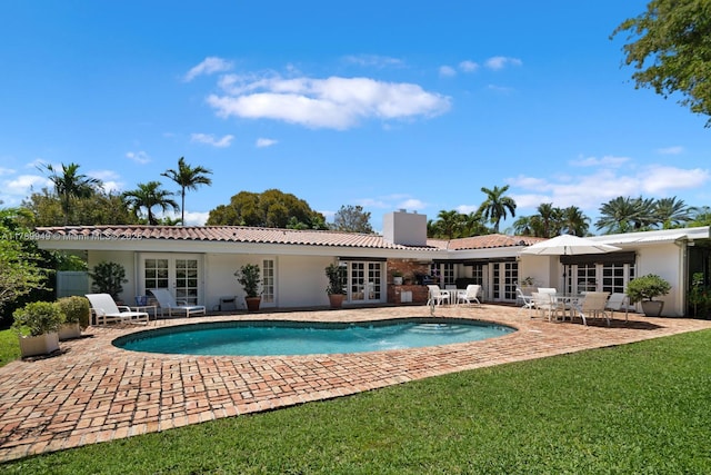 141 Island Dr, Key Biscayne, FL 33149 - pool featuring french doors, a yard, and a patio area