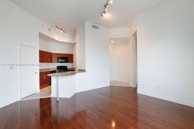 7280 SW 90th St Unit 703, Miami, FL 33156 - kitchen with track lighting, black appliances, wood finished floors, and visible vents