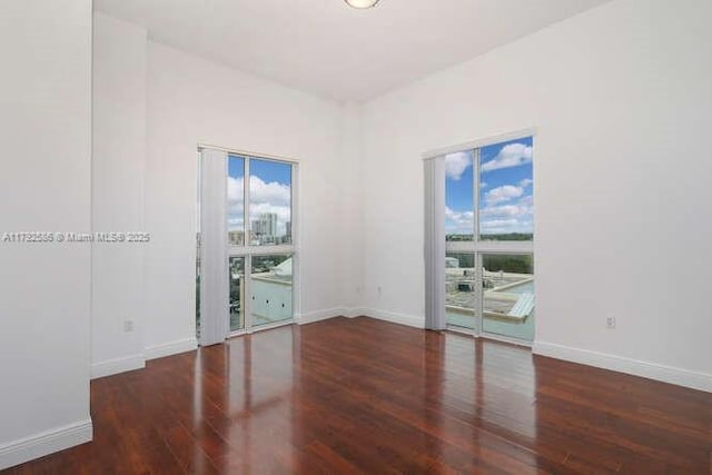 7280 SW 90th St Unit 703, Miami, FL 33156 - empty room with baseboards and wood finished floors