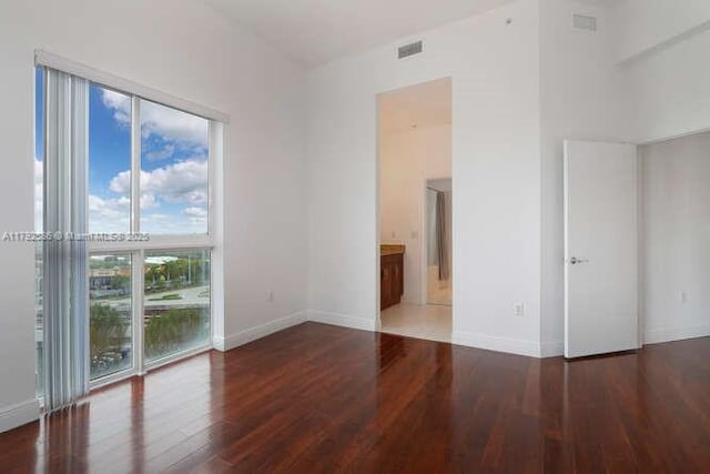 7280 SW 90th St Unit 703, Miami, FL 33156 - empty room featuring baseboards, visible vents, and wood finished floors