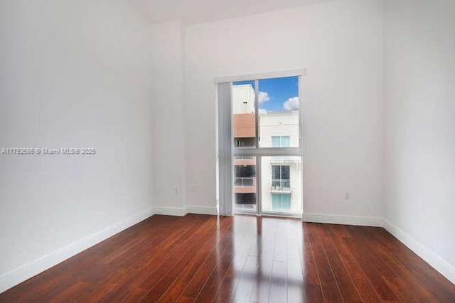 7280 SW 90th St Unit 703, Miami, FL 33156 - spare room with baseboards and dark wood finished floors