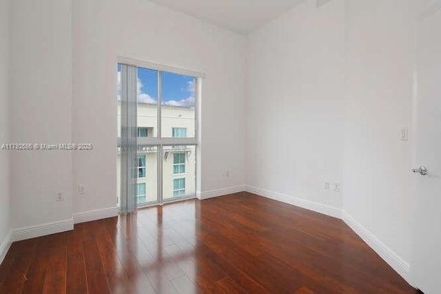 7280 SW 90th St Unit 703, Miami, FL 33156 - empty room with baseboards, wood finished floors, and a wealth of natural light