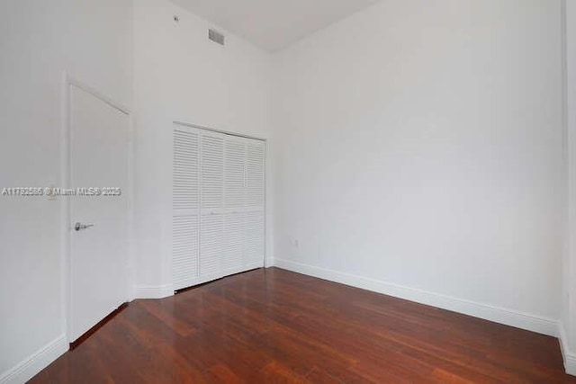 7280 SW 90th St Unit 703, Miami, FL 33156 - unfurnished bedroom featuring baseboards, visible vents, and wood finished floors