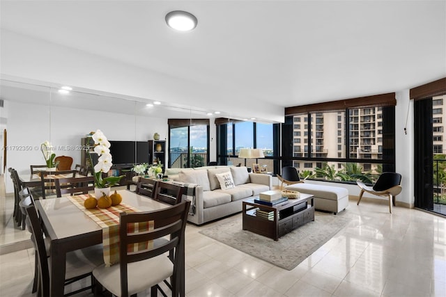 living room with floor to ceiling windows and light tile patterned flooring