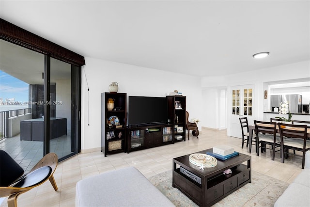 living area featuring french doors and tile patterned flooring