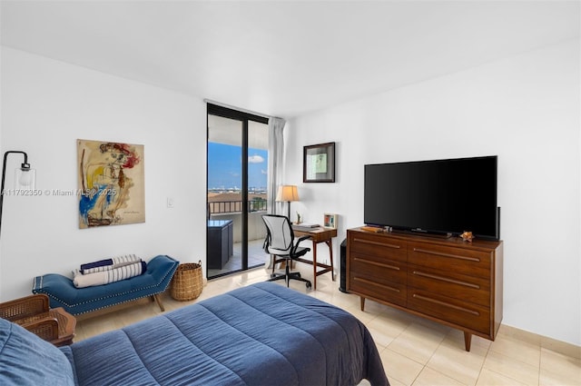 bedroom with expansive windows, light tile patterned floors, and access to exterior