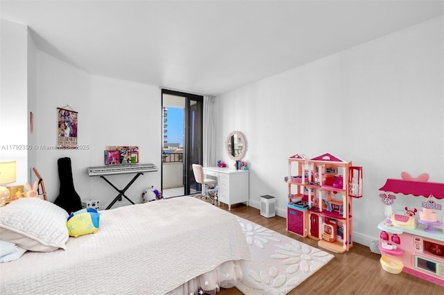 bedroom with baseboards and wood finished floors