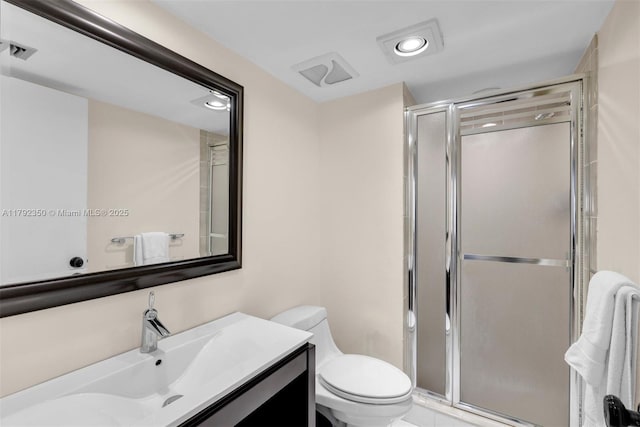 bathroom featuring vanity, toilet, recessed lighting, and a stall shower