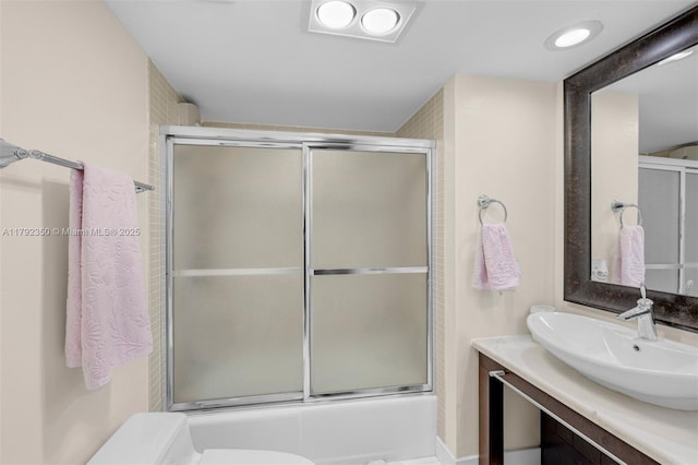full bath with toilet, enclosed tub / shower combo, and vanity