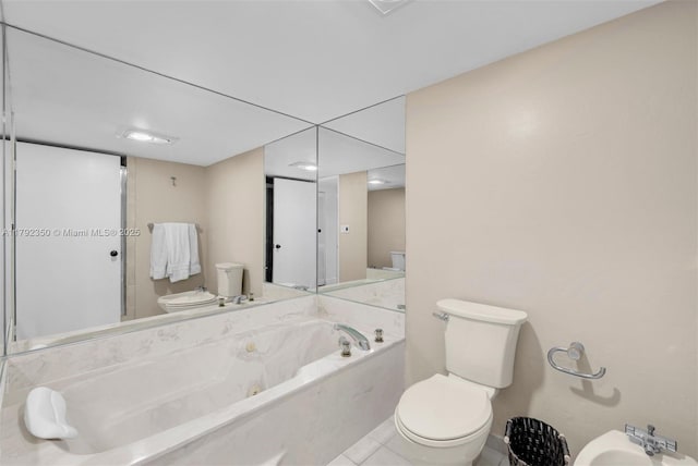bathroom with toilet, tile patterned floors, a bidet, and a jetted tub