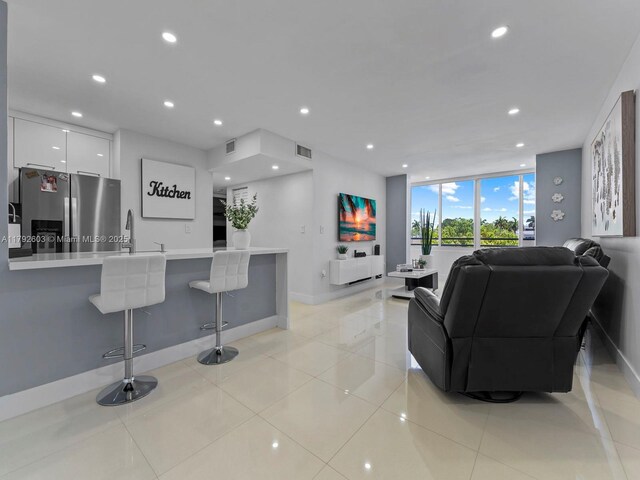 11715 SW 18th St Unit 304, Miami, FL 33175 - living room with recessed lighting, light tile patterned floors, and baseboards