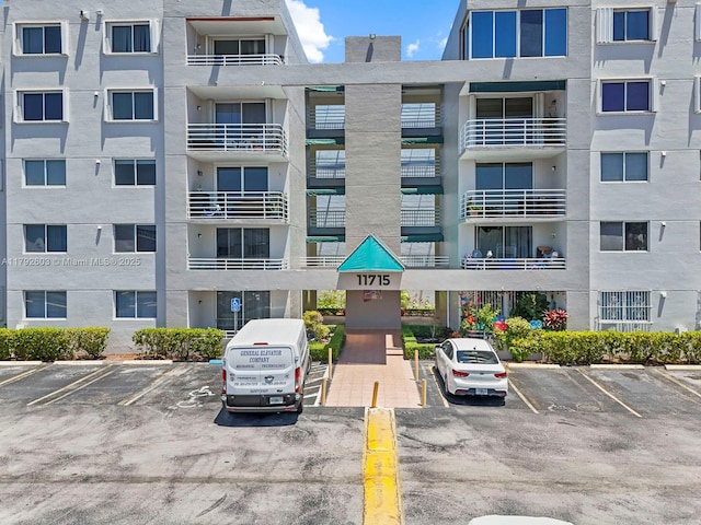 view of building exterior featuring uncovered parking