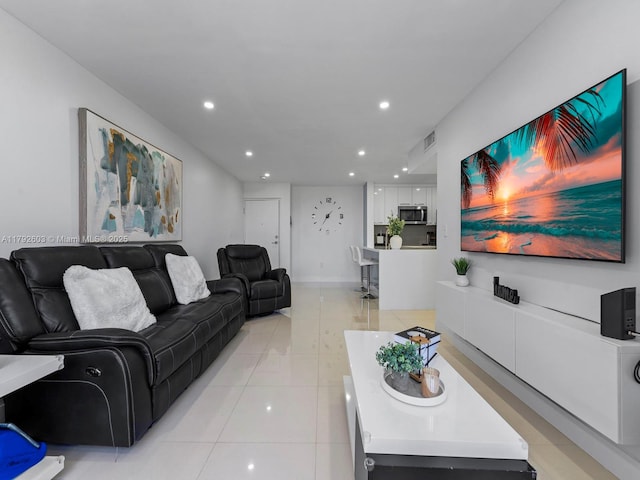 living room with light tile patterned floors, recessed lighting, and visible vents
