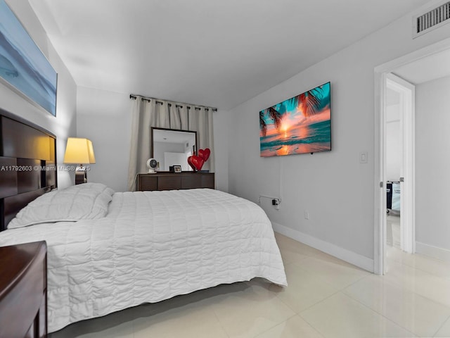 tiled bedroom featuring baseboards and visible vents