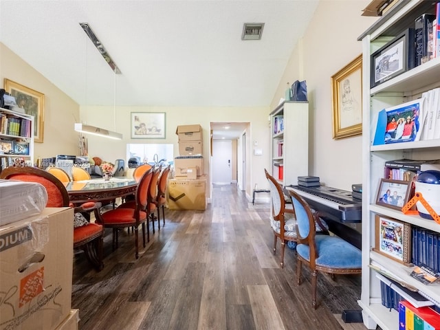 dining space featuring lofted ceiling, dark wood-style floors, and visible vents