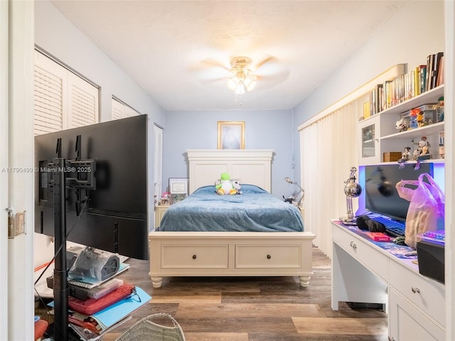 bedroom featuring ceiling fan and dark wood-type flooring