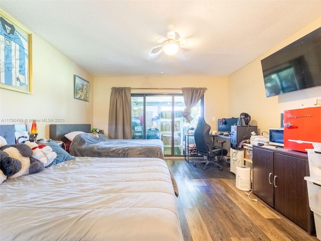 bedroom featuring access to outside, a ceiling fan, and wood finished floors