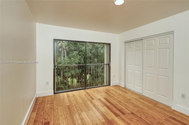 3905 Adra Ave Unit J-46B, Doral, FL 33178 - unfurnished bedroom featuring light wood finished floors and a closet