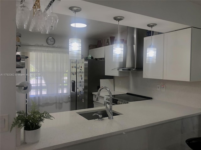 1101 Bahama Bnd Unit B2, Coconut Creek, FL 33066 - kitchen with wall chimney range hood, white cabinetry, decorative light fixtures, and a sink