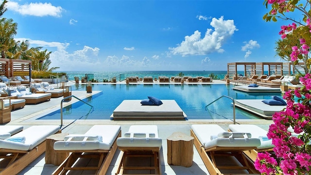 view of swimming pool with a water view and an outdoor hangout area