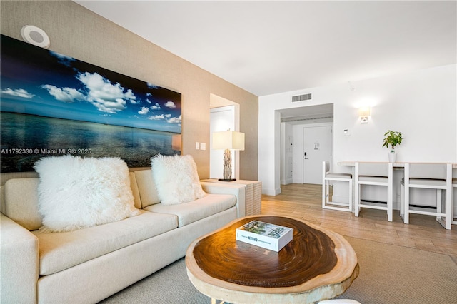 living room with wood finished floors and visible vents