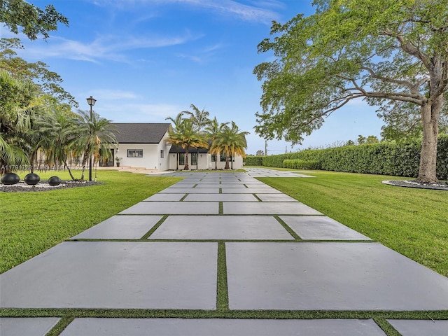 view of front facade with stucco siding and a front lawn