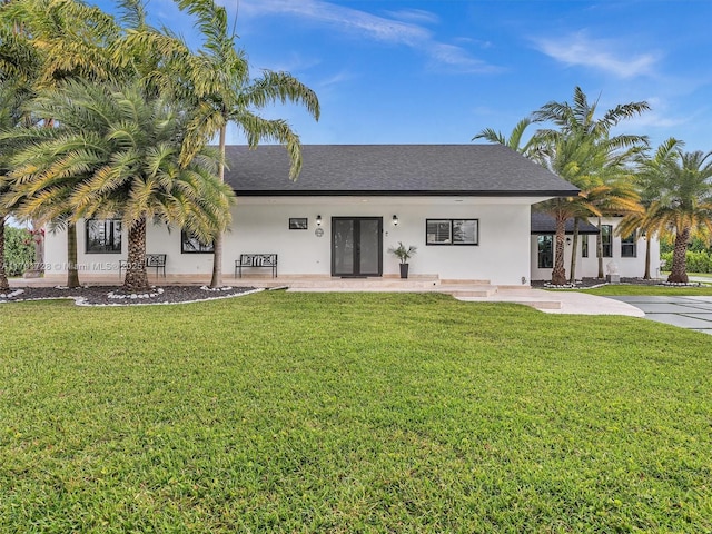 21411 SW 248th St, Homestead, FL 33031 - back of property with french doors, stucco siding, a yard, and a shingled roof