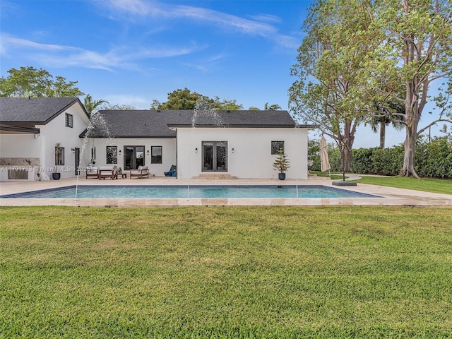 pool with a patio and a yard