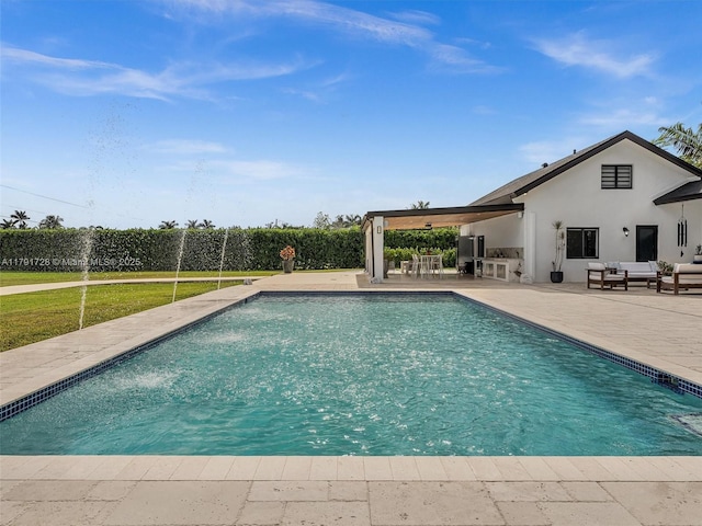 view of pool featuring a patio, outdoor lounge area, and a fenced in pool