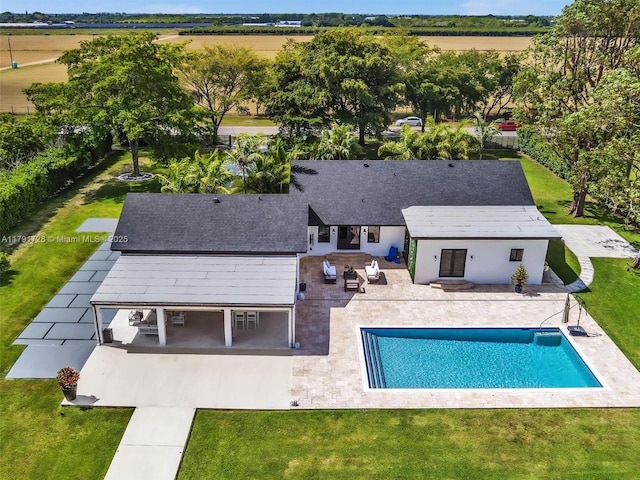 pool featuring a yard, fence, and a patio area