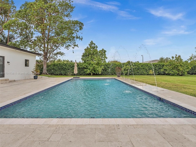 view of pool with a lawn, a fenced in pool, and a patio