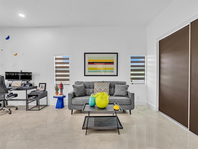 living room with baseboards and recessed lighting
