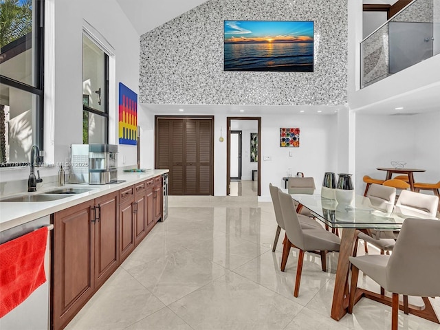 dining room featuring high vaulted ceiling and marble finish floor